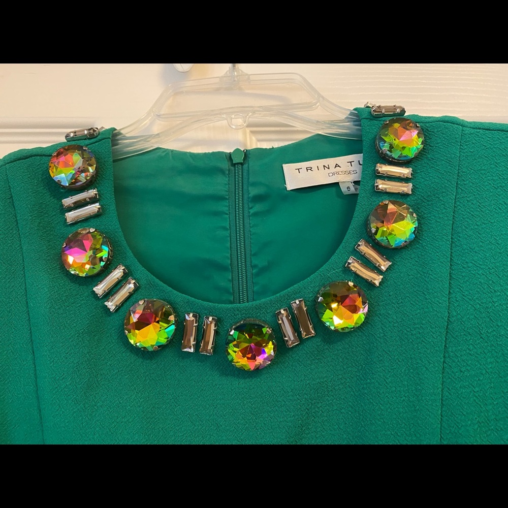 Trina Turk green sleeveless dress with jewels around the neck.